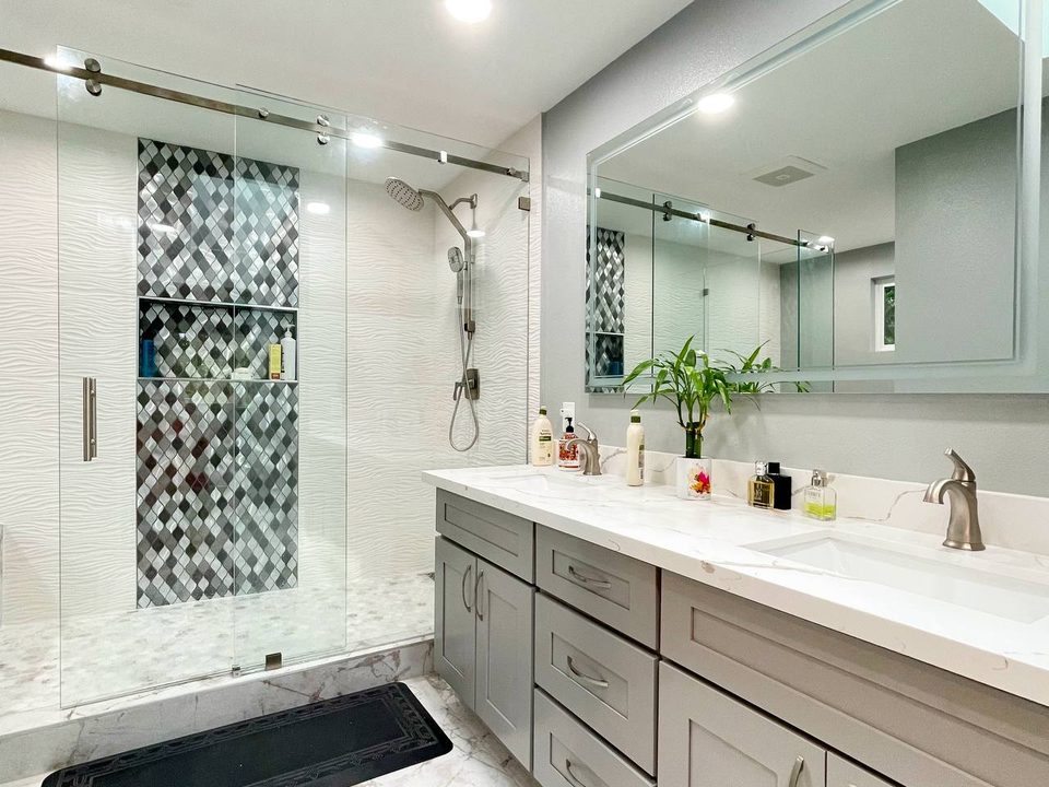 Double vanity with quartz countertop and wall sconces