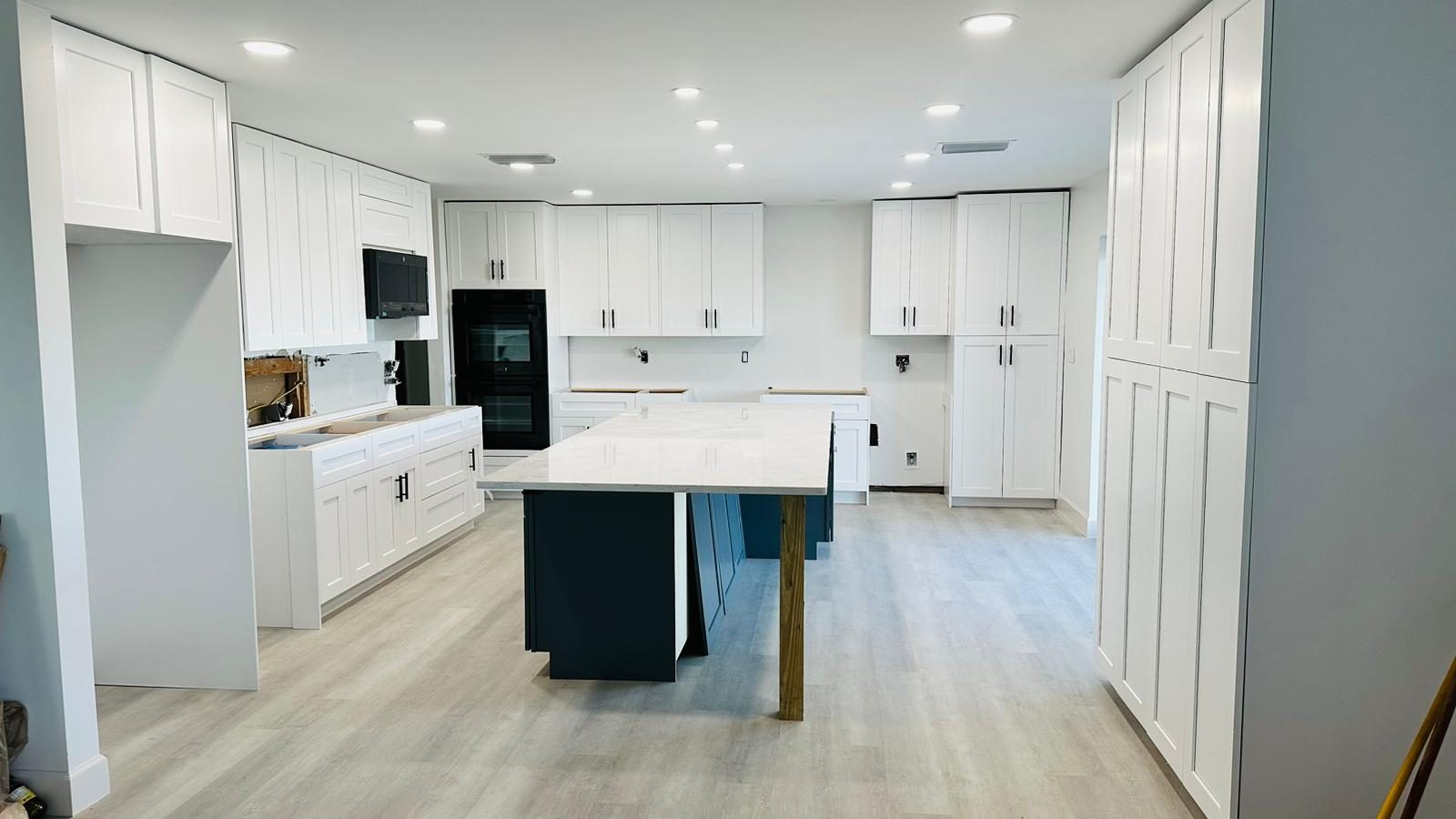 Remodeled kitchen interior with light flooring and clean cabinet transitions